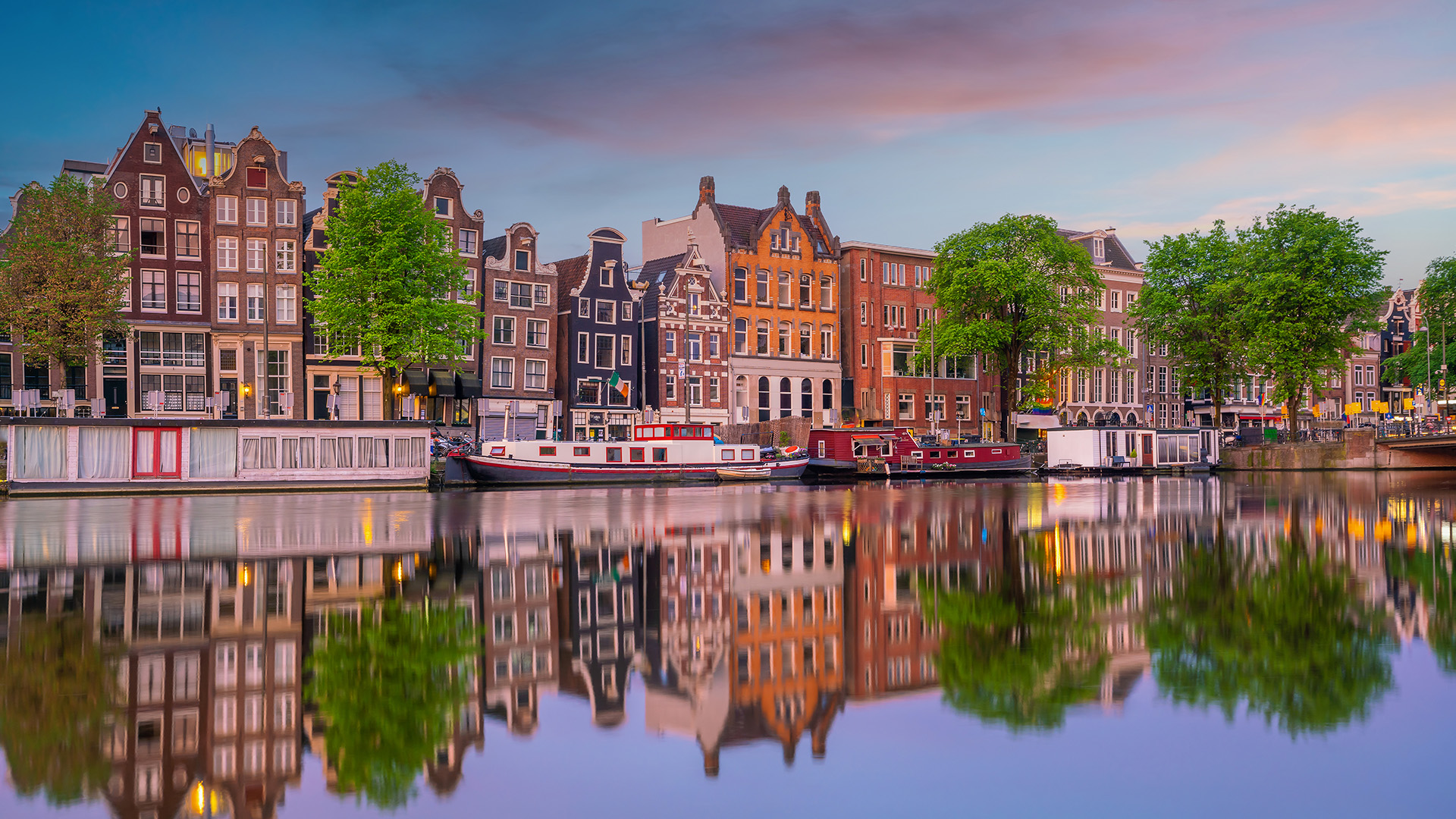 Amsterdams kanaler spejler de smukke gamle huse og skaber en rolig stemning midt i den livlige by